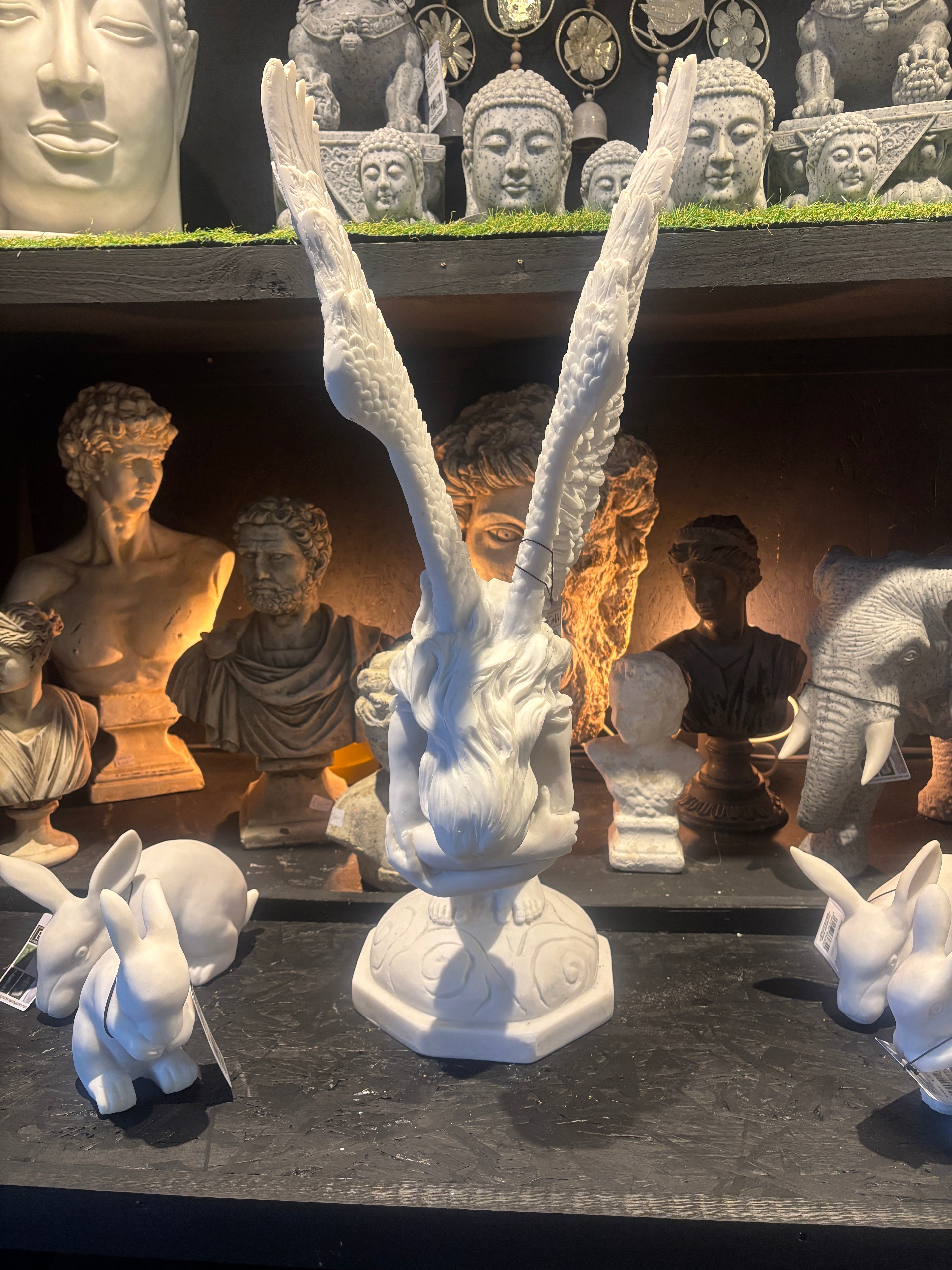 Collection of white stone sculptures on a dark surface