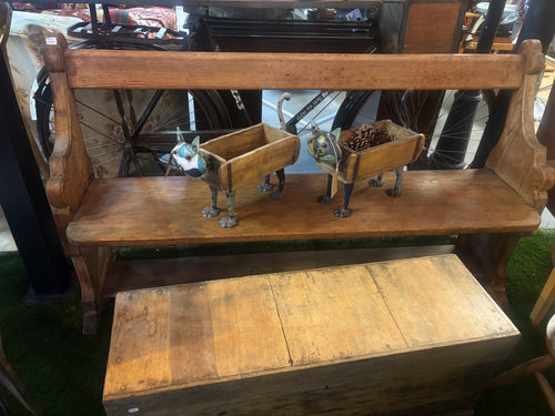 Wooden bench with decorative elements on a grassy background