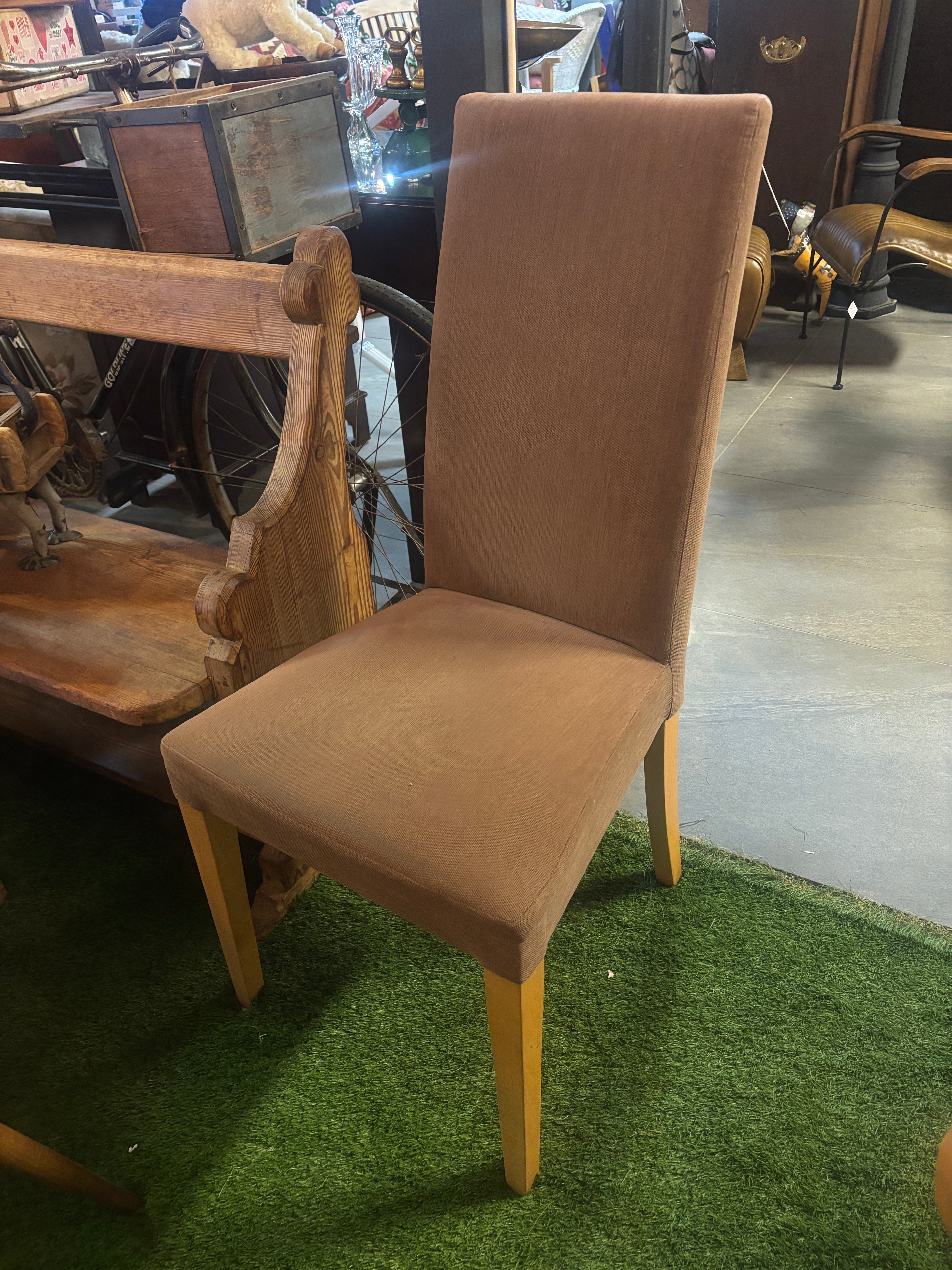 Brown chair on a green grass-like surface