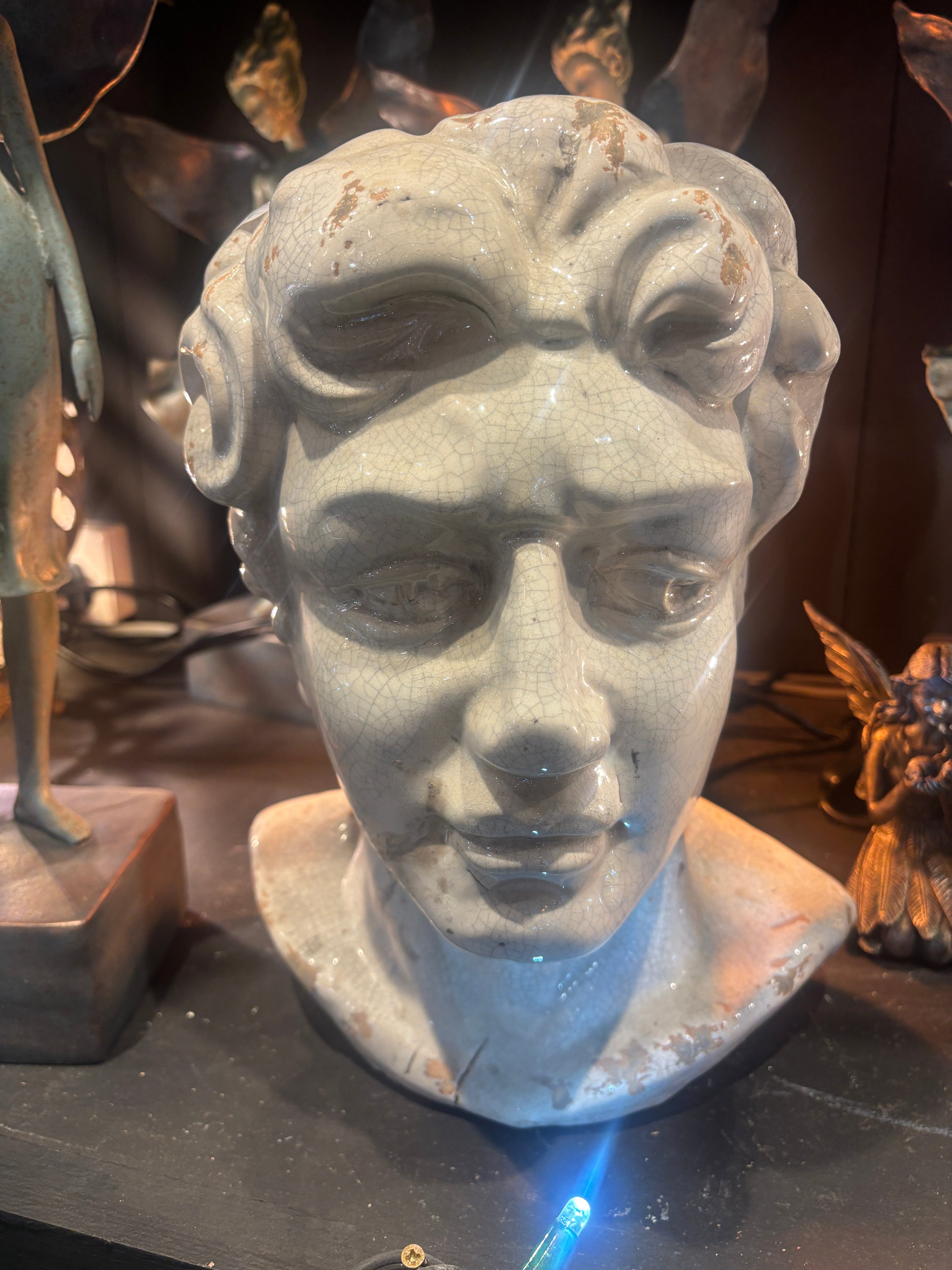 Stone sculpture of a face with a dark background