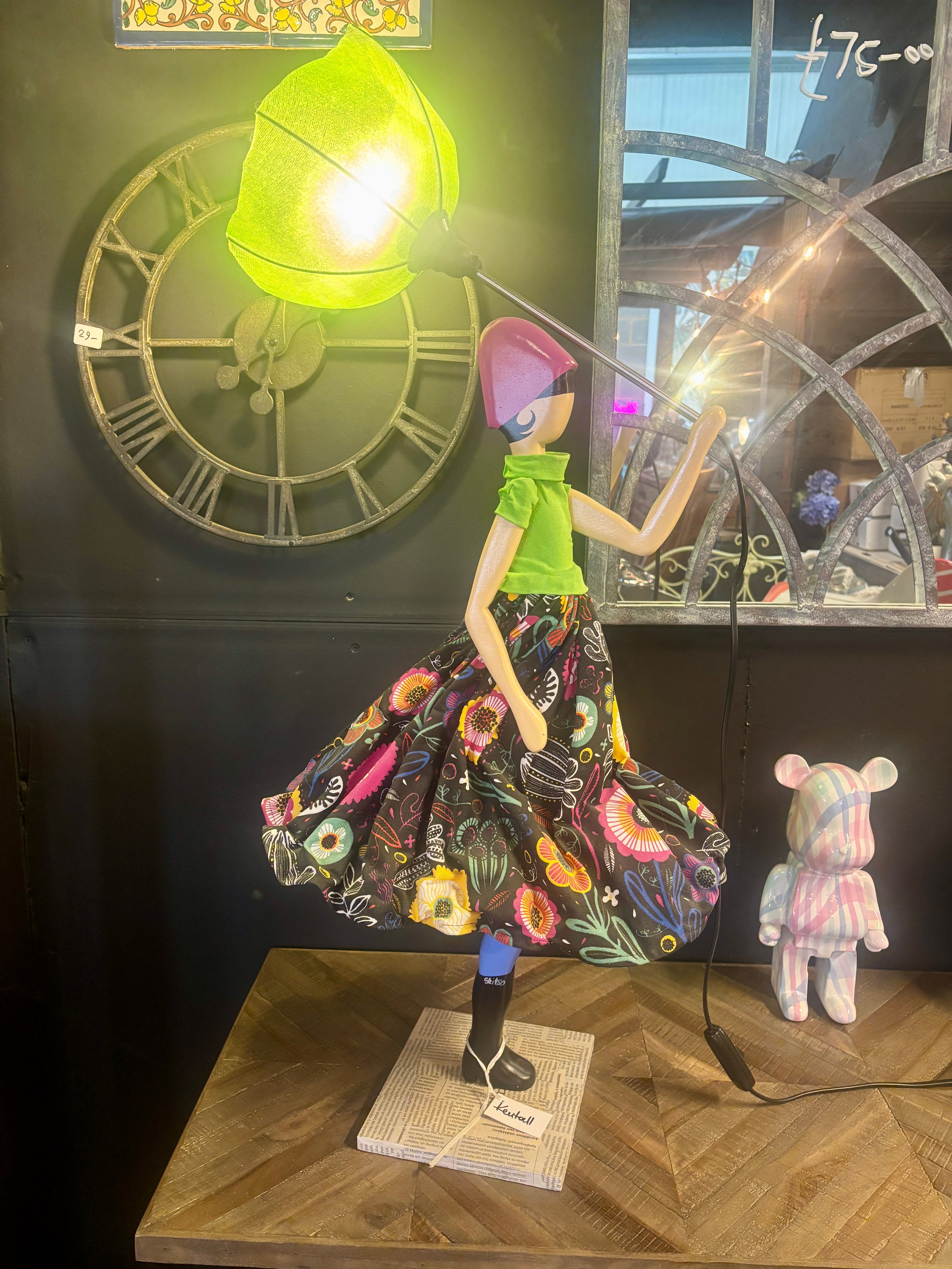 Lady Lamp holding an inverted umbrella