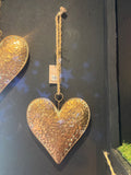 Large Gold metal heart hanging from a rope