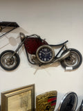 Vintage-style clock with wheels on a white wall
