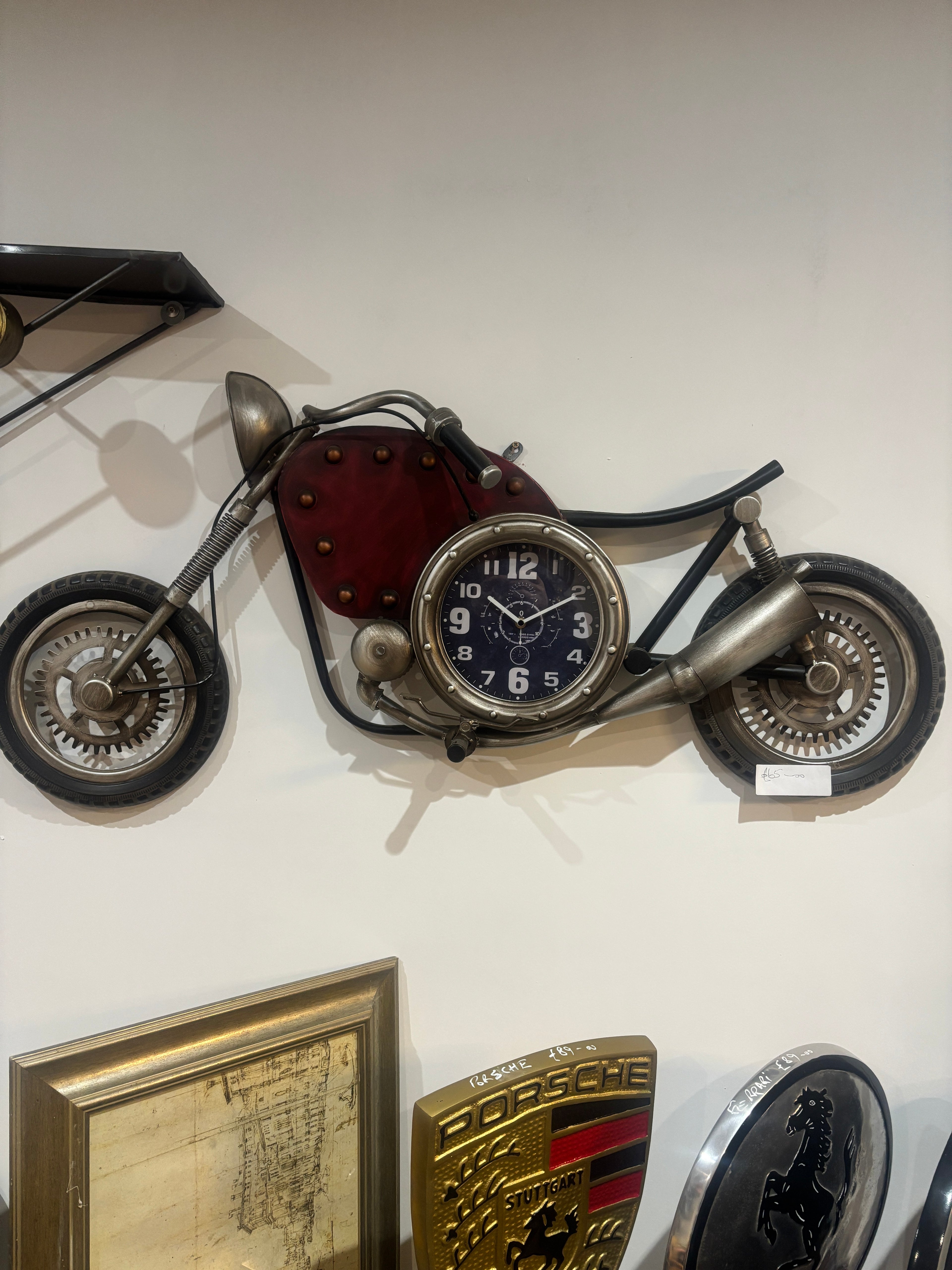 Vintage-style clock with wheels on a white wall