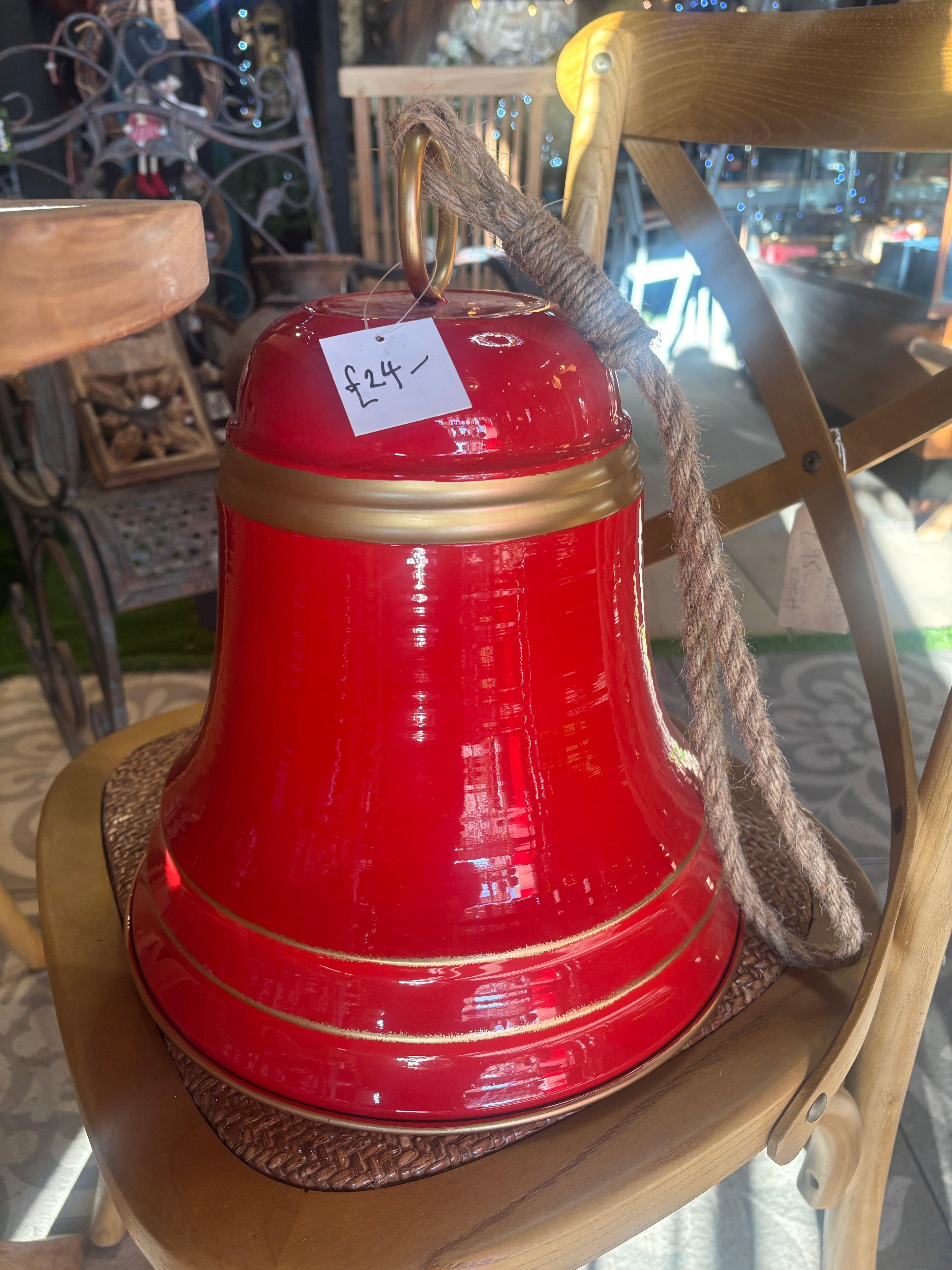 Large Red metal Christmas Bell hanging from a rope
