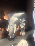 Stone elephant sculpture on a dark surface