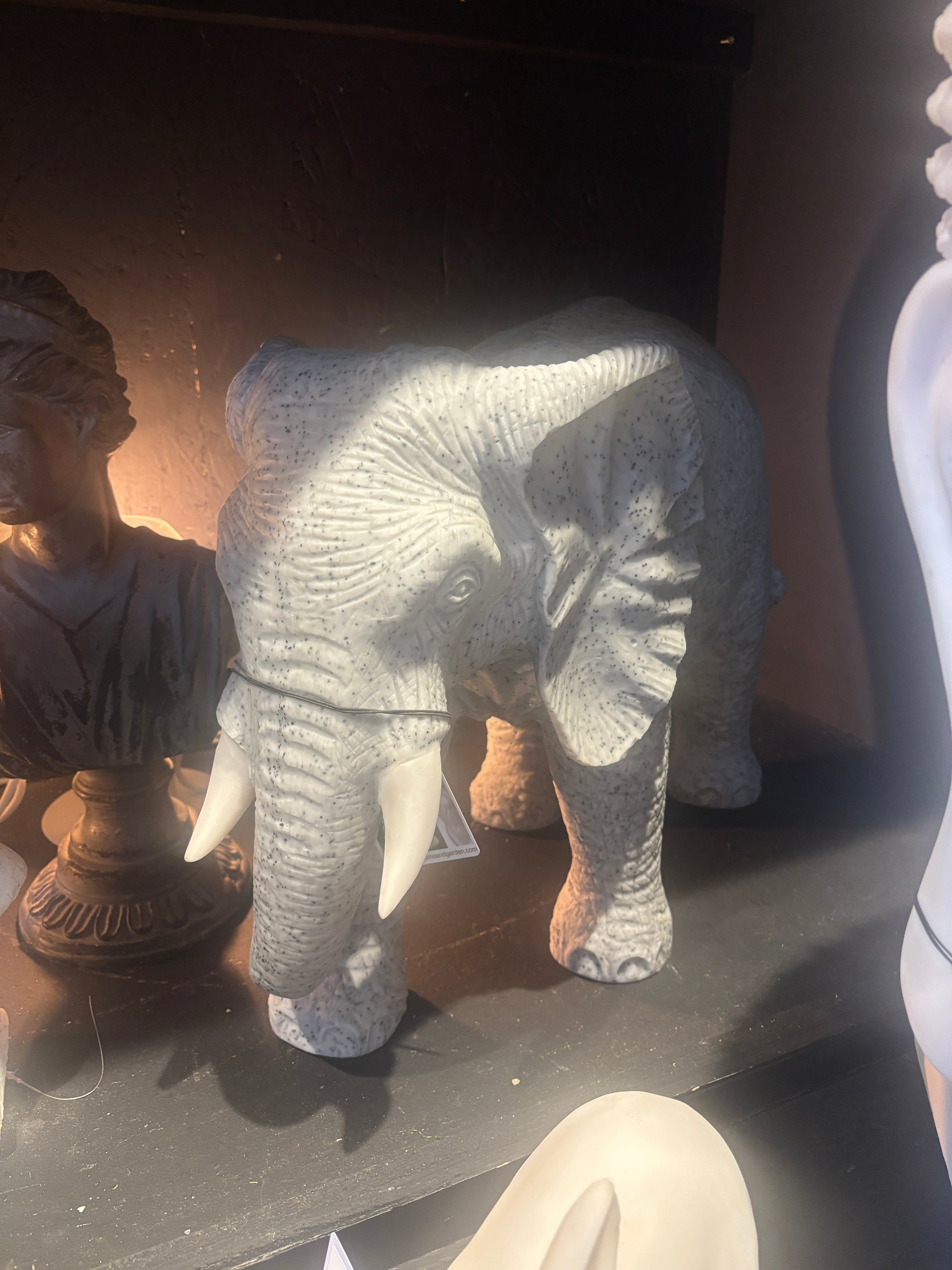 Stone elephant sculpture on a dark surface