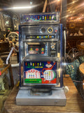 Vintage arcade machine with colorful panel on a wooden surface