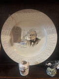 Decorative plate with a Winston Churchill printed design on a dark surface