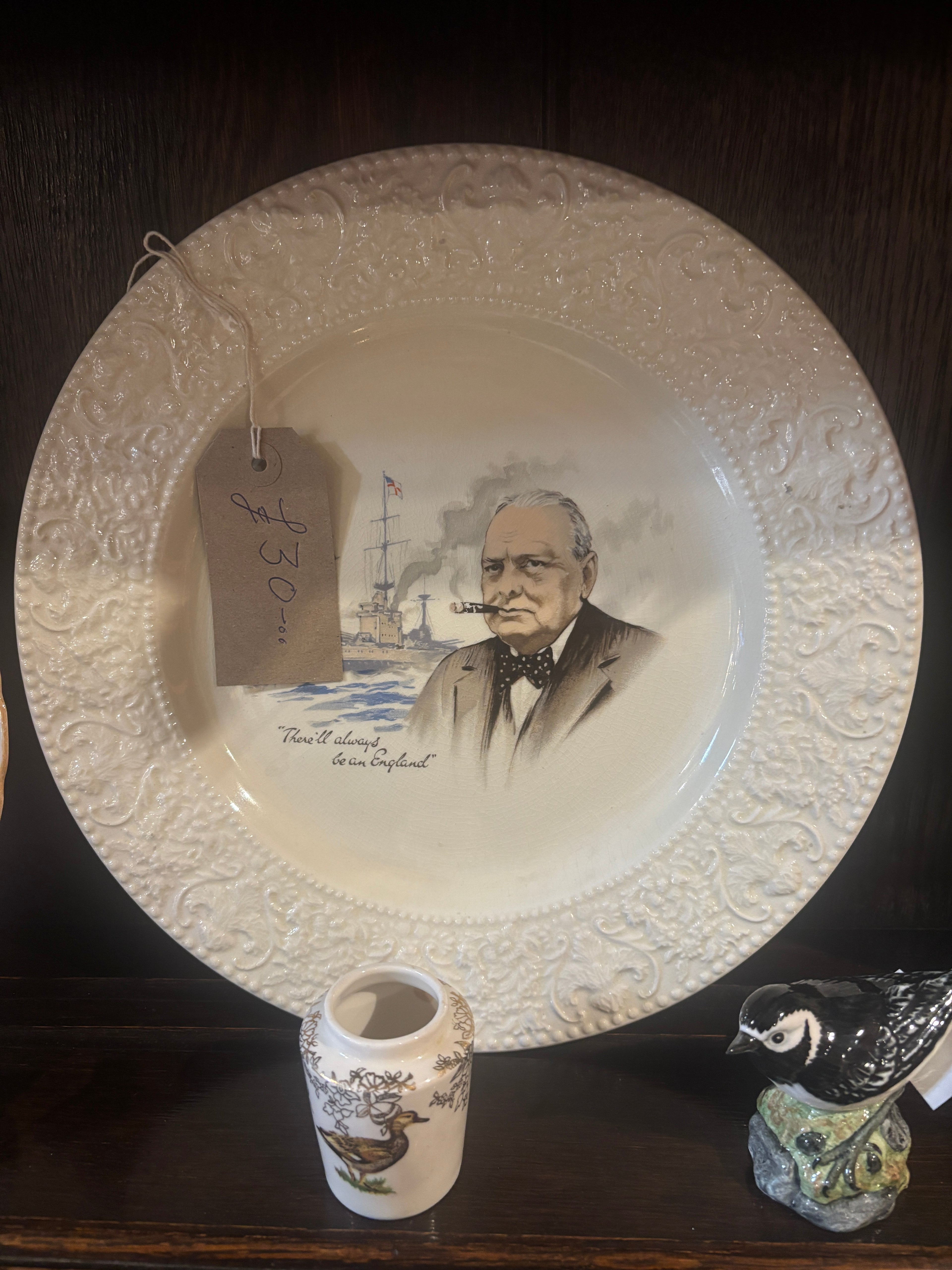 Decorative plate with a Winston Churchill printed design on a dark surface